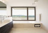 Bath Room, Ceiling Lighting, Wall Lighting, Travertine Floor, Vessel Sink, and Drop In Tub  Photo 11 of 13 in Object 340 - combination of quality and comfort by meier architekten zurich