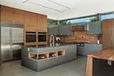 Kitchen, Engineered Quartz Counter, Porcelain Tile Backsplashe, Wall Oven, Undermount Sink, Colorful Cabinet, Wood Cabinet, Refrigerator, Ceiling Lighting, Range Hood, Porcelain Tile Floor, and Cooktops  Photo 5 of 10 in Bel Air Home by Tagliaferri Architects, Inc