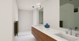 Master en suite bath featuring a separate toilet room, his and her sinks and walk-in shower.
