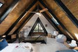Bedroom, Bed, Dresser, Wardrobe, Chair, Carpet Floor, Table Lighting, and Pendant Lighting  Photo 8 of 17 in Big Bear A-Frame Receives Boho Eclectic Transformation by Courtney Poulos