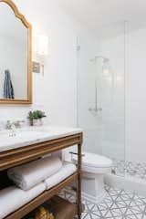 Bath Room, Open Shower, Marble Floor, Wall Lighting, One Piece Toilet, Marble Counter, and Undermount Sink Guest Bathroom with Waterproof Plaster Wall Treatment and Restoration Hardware Vanity  Photo 18 of 45 in The Perfect Spanish by Courtney Poulos