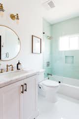 Guest Bathroom Featuring Bright Subway Tile and Brushed Brass Detail - 2444 Exposition Place