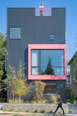 As the name implies, the exterior of Best Practice's Big Mouth House resembles an open-mouthed face with its powder pink framing against the black metal facade.