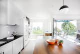 A comprehensive remodel to this traditional kitchen allows for natural light and accommodates the chefs with custom, new cabinetry, storage and a salvaged, customized island. 