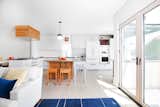 A comprehensive remodel to this traditional kitchen allows for natural light and accommodates the chefs with custom, new cabinetry, storage and a salvaged, customized island. 