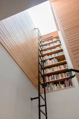 Vertical bookcase at stair landing