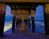 About the Beach Photograph:
Under the Pier is a beautiful landscape photograph that was created at twilight under the fishing pier at Woodland Beach during a walk along the pebbled beach.
Title: Under the Pier
Landscape Photographer: Melissa Fague
Genre: Landscape Photography
Item ID#: LAND-0061
This landscape photograph is one of many available for purchase through www.pipafineart.com. You have your chose of size and print materials. All of our landscape pictures are printed on high quality materials and the highest quality ink for longevity. Each photo print is also coated with a soft luster finish. If you need assistance we are always available; please contact us with any questions.