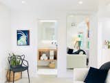 The bathroom features a modern floating vanity, backlight mirror and floating vessel sink.