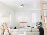 The spacious living room is full of light and warmth and features a projection system with art for any occasion.