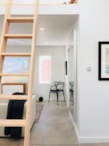 The living room includes Bang & Olufsen speakers, Masters Chair and plenty of room for friends and family.