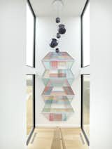 Adrian Esparza's art piece spans the stairwell, flanked by floor to ceiling windows pouring in natural light.  Photo 1 of 17 in North Dallas by Mary Anne Smiley