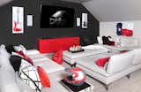 The space above the garage, previously unutilized, was converted to the ultimate gaming space for the two boys. A red lacquer wall hung console hangs below a large flat screen tv. The modular sectional can be maneuvered to have deeper seats, perfect for sleepovers. 