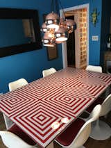 Custom dining table I built for around $150, two by fours, OSB, and painted subsurface glass inspired by the Op art movement. 