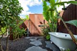 Outdoor rain shower and free standing Victoria & Albert clawfoot tub made of rust-free lava.