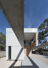 concrete beams, walls and paving serve as containing envelopes and a threshold for handmade brick structures which house the rooms on the lower floor