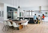 Kitchen and dining area, visually integrated, through the continuity of ground and ceiling plane and material, while still maintaining a distinct sense of individual place.