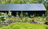Exterior, Butterfly RoofLine, House Building Type, Metal Roof Material, Gable RoofLine, and Wood Siding Material The house is nestled in the front garden, which is also the septic field.  Photo 1 of 14 in Appalachian Black Dogtrot by Jay Sifford