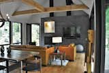 Living Room, Sofa, Wall Lighting, End Tables, Table Lighting, Wood Burning Fireplace, Chair, Coffee Tables, and Light Hardwood Floor Another view of the great room.  Photo 4 of 14 in Appalachian Black Dogtrot by Jay Sifford