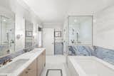 The master bathroom, clad in Bianco marble. 