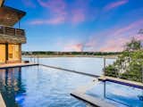 Backyard infinity edge pool opens out onto beautiful Lake Travis
