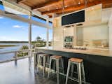 The open concept kitchen includes large windows looking out onto Lake Travis