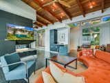 Open concept living space includes vaulted beamed wood ceilings