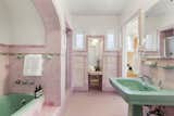 Restored bathroom with original pink tile and green fixtures