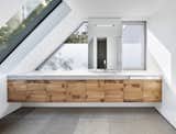 Bath Room, Concrete Counter, Porcelain Tile Floor, Wall Mount Sink, and Ceiling Lighting  Photo 10 of 14 in House K by Architekten Wannenmacher + Möller 