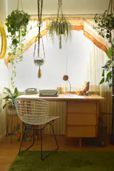 Midcentury Florence Knoll desk and Bertoia chair nestled within an assortment of planters sourced from local estates.