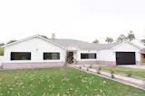 Front elevation with detailed walkway, rustic sconces and beautiful driveway pavers.