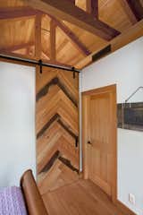 A flat track sliding door was crafted with a mixture of wood "scraps" from the job site.