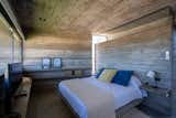 Bedroom, Concrete Floor, Bed, Table Lighting, Shelves, and Ceiling Lighting  Photo 20 of 33 in La Marina House