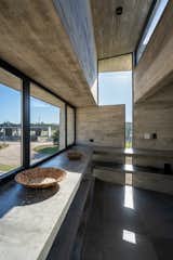Kitchen, Concrete Floor, Open Cabinet, and Concrete Counter  Photo 18 of 33 in La Marina House by Besonías Almeida arquitectos