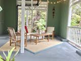 Outdoor, Concrete Patio, Porch, Deck, Large Patio, Porch, Deck, Vertical Fences, Wall, and Hanging Lighting Ground level lounge area for morning coffees or evening wines.   Photo 11 of 11 in Romantic Tree Cottage in the Hawaiian Rainforest by Shannon Victoria