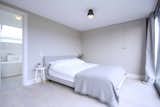 Bedroom, Bed, Storage, Lamps, Ceiling Lighting, Medium Hardwood Floor, Light Hardwood Floor, and Dark Hardwood Floor  Photo 5 of 6 in SW House by Studio AVC