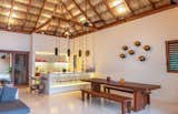 The kitchen sits at the heart of the space, featuring oversized, swinging bar seats.  Combining  local craftsmanship and materials with state of the art appliances the minimal kitchen is supported by a full butler's kitchen in the back and accessible by a separate service entrance.