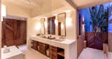 With the open air, ocean view outdoor shower, the master bath features his and her sinks and amazing locally crafted wood cabinetry and details thoughout.