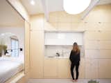 Kitchen, Wood Cabinet, Porcelain Tile Floor, Ceiling Lighting, and Wall Lighting  Photos from Urban Cocoon in Paris