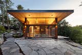 Exterior, House, Metal, Flat, Wood, Beach House, and Butterfly side view with lift and slides onto stone terrace cliff  Exterior Metal House Flat Butterfly Photos from Stanley Bay House