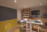 Children's craft room with wall of white board, chalk board and pin up space