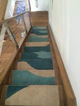 Wave Steps in a Newport Rhode Island home are nicely paired with a surfboard entry rug!