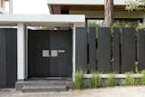 Outdoor, Grass, Metal Fences, Wall, Front Yard, Vertical Fences, Wall, and Gardens the gate - closed  Photo 4 of 28 in Screened House by design and structures