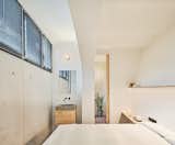 Bedroom, Night Stands, Wall Lighting, Accent Lighting, Bed, Terra-cotta Tile Floor, and Shelves The main bedroom with exposed water basin and bathroom  Photo 1 of 31 in Yurikago House by Mas-aqui