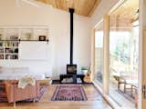 An energy-efficient, Danish wood-burning stove by Rais anchors one corner of the living room.   Photo 6 of 18 in Westwood House by Assembly Architecture & Build, PLLC