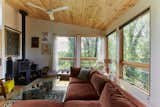 Living Room, Sectional, Medium Hardwood Floor, Corner Fireplace, Wood Burning Fireplace, and Ceiling Lighting  Photo 4 of 14 in Merion House by Assembly Architecture & Build, PLLC