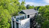 Exterior, House Building Type, Flat RoofLine, Metal Roof Material, Gable RoofLine, Small Home Building Type, and Wood Siding Material A bird's eye view in the trees  Photo 2 of 8 in A Modern Compound in a Historic City by Chris Bonner