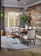 The 84" x 40" table and bench are a Live Edge Table. The chandelier was sourced from Restoration Hardware. The wall was built custom by Palacios Design Co. The rug is Jaipur. 