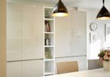 Ceiling Lighting, Pendant Lighting, and Laminate Cabinet After: the kitchen with a sleek new storage solution  Photo 3 of 8 in White and Cream Kitchen - renovation of a living space in Brussels by Standing Renovation