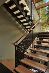 Wood and steel stair with custom waterjet-cut steel railing panels