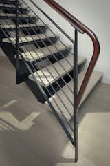 Stair detail with steel railing and sapele wood top rail.